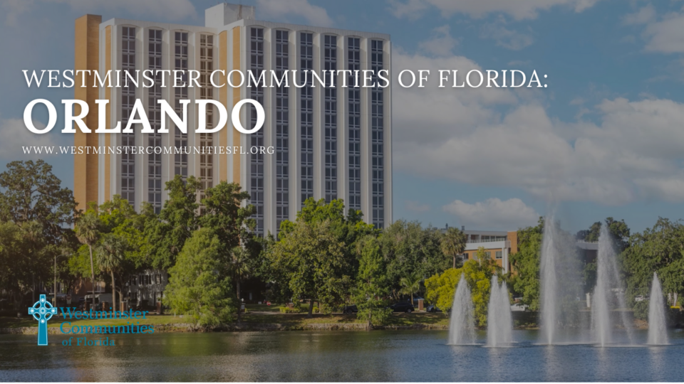 senior living community building behind trees and a lake with a fountain