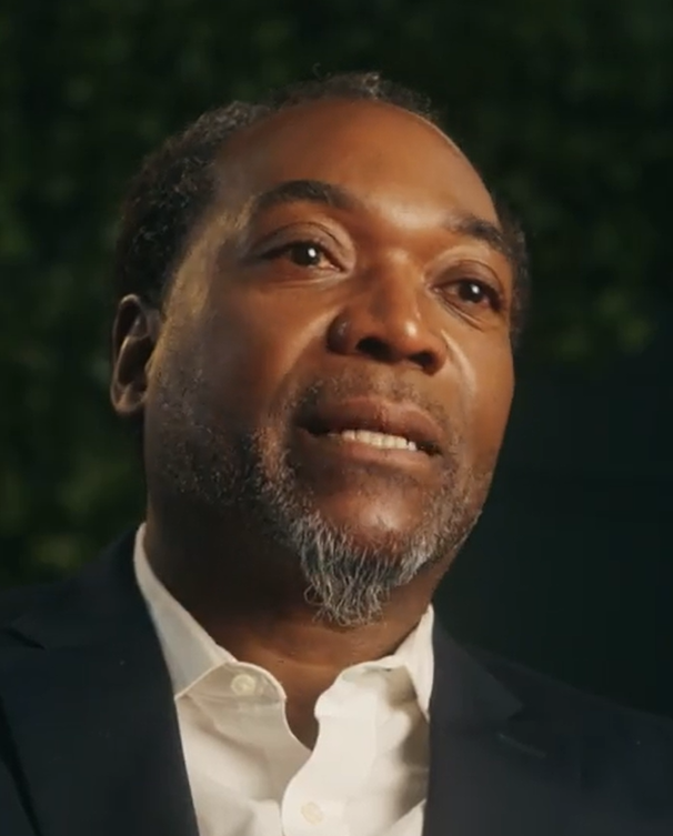 black man with goatee in suit